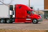 red and white truck on road during daytime