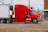 red and white truck on road during daytime