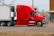 red and white truck on road during daytime