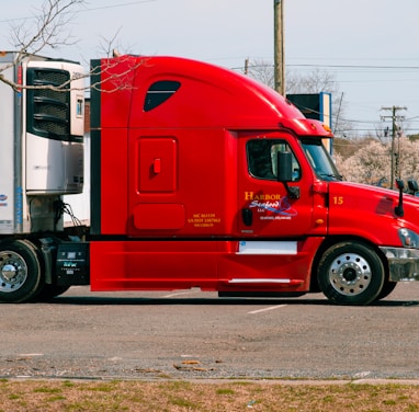 red and white truck on road during daytime