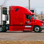 red and white truck on road during daytime