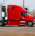 red and white truck on road during daytime