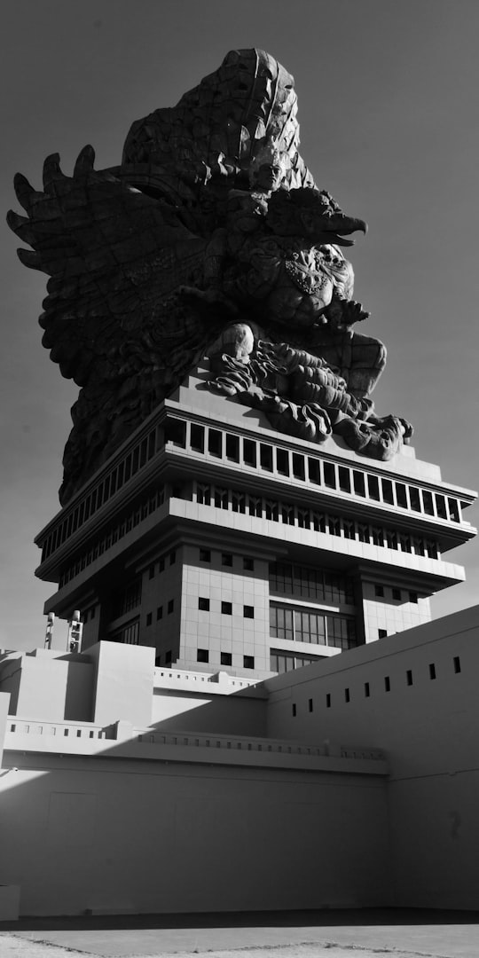 grayscale photo of concrete building in Garuda Wisnu Kencana Cultural Park Indonesia