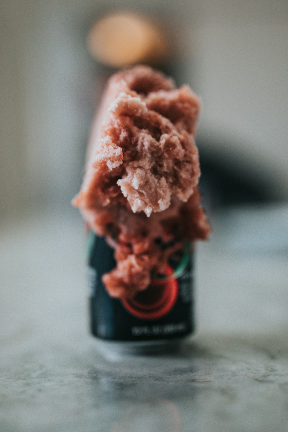 black and red can on white table