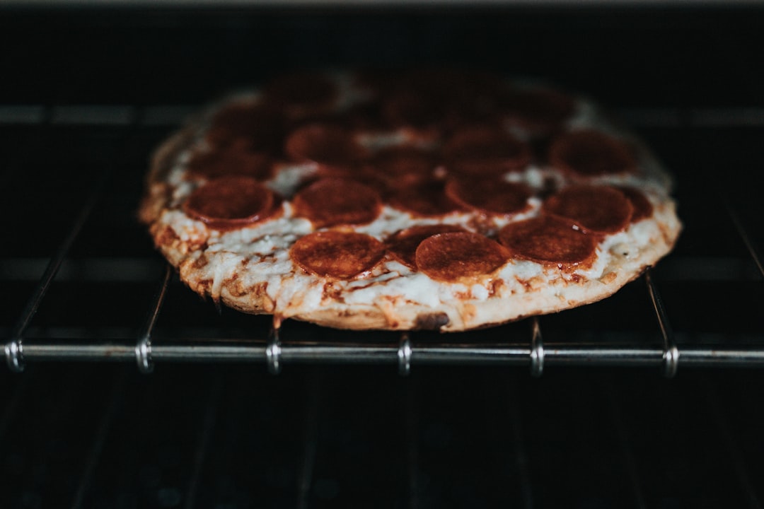 brown and white pizza on stainless steel grill