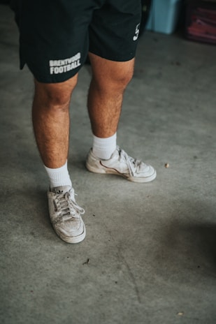 man in white nike athletic shoes