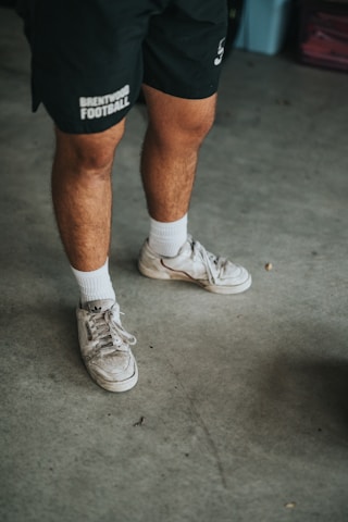 man in white nike athletic shoes