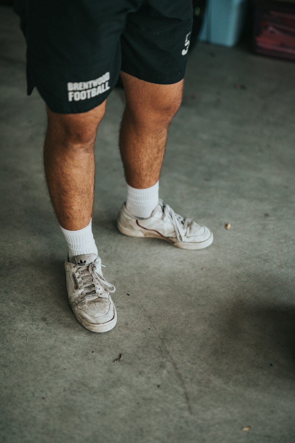 man in white nike athletic shoes