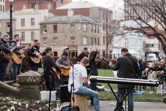 man in blue long sleeve shirt playing electric guitar