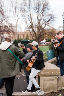 man in green jacket playing violin