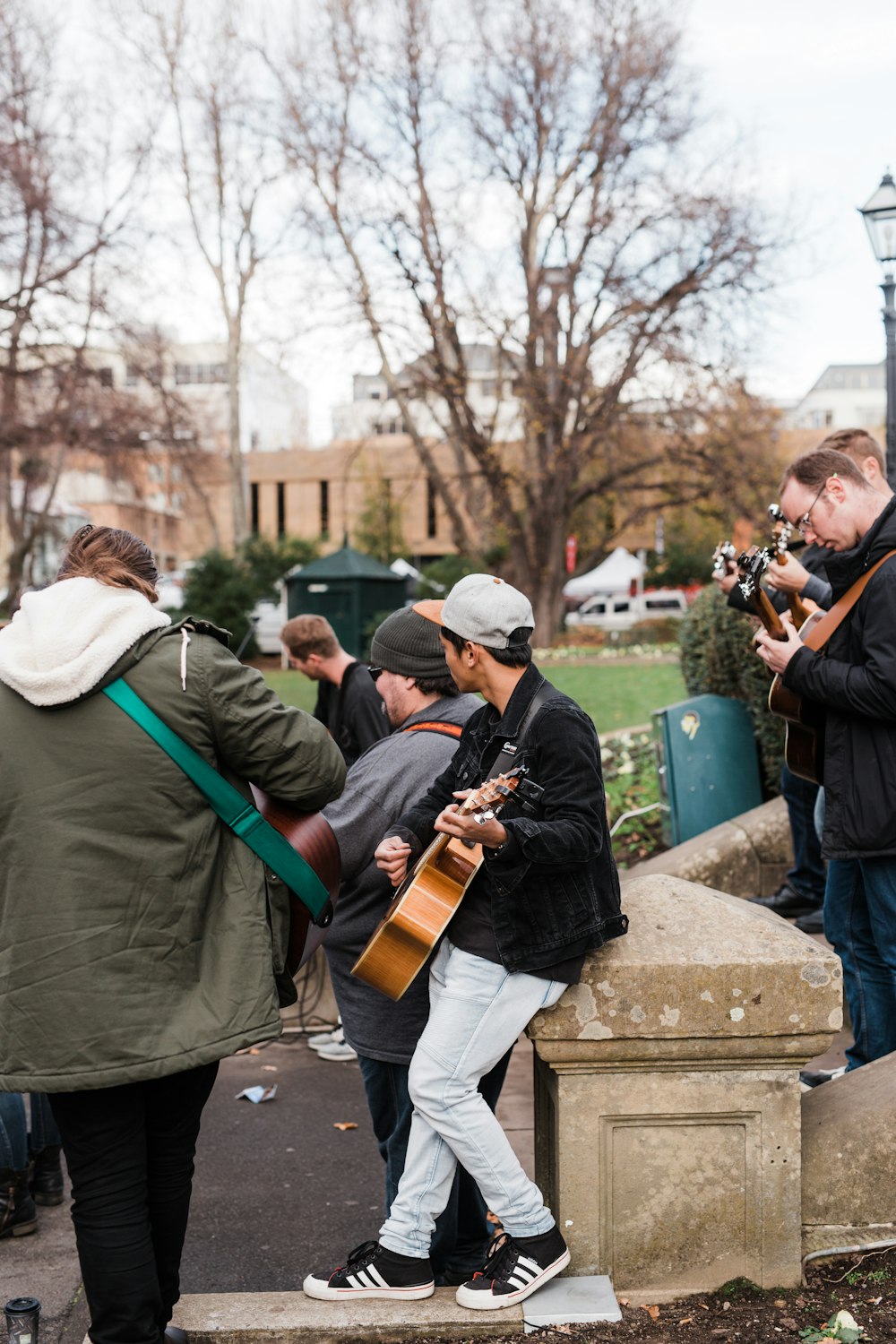 man in green jacket playing violin