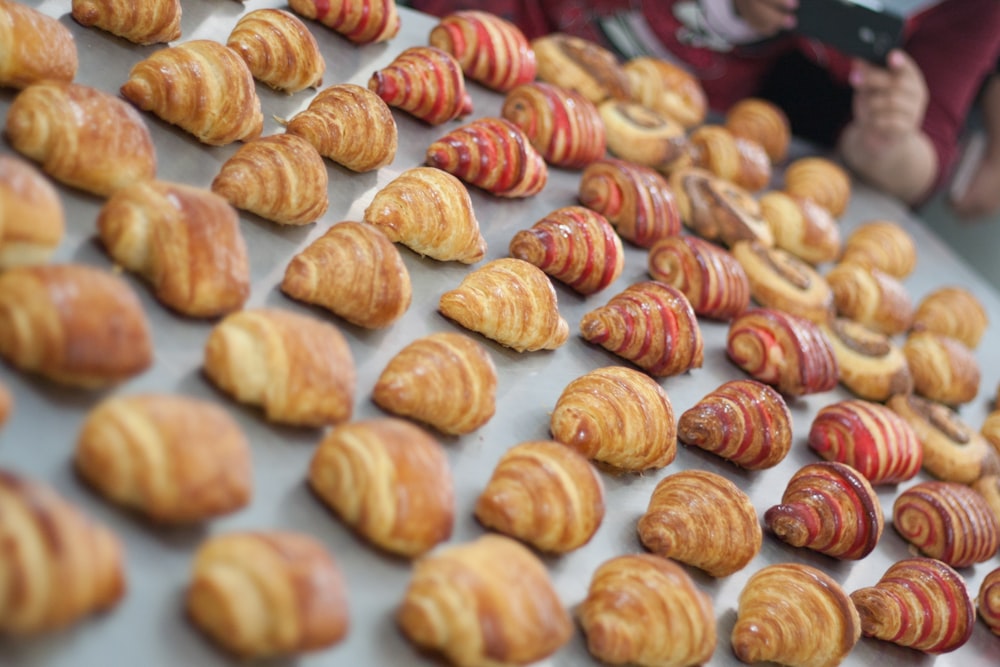 brown and white cookies on white and red textile