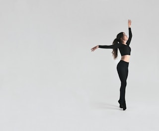 A fitness trainer demonstrating proper body posture during a dance routine.
