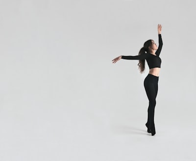 woman in black sports bra and black leggings dance zoom background