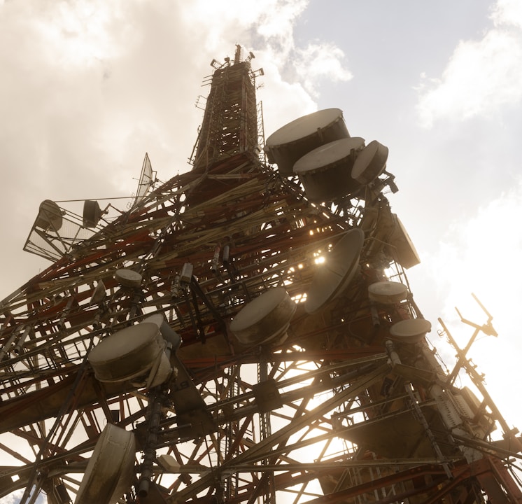 brown and white ferris wheel under white clouds during daytime