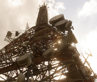 brown and white ferris wheel under white clouds during daytime