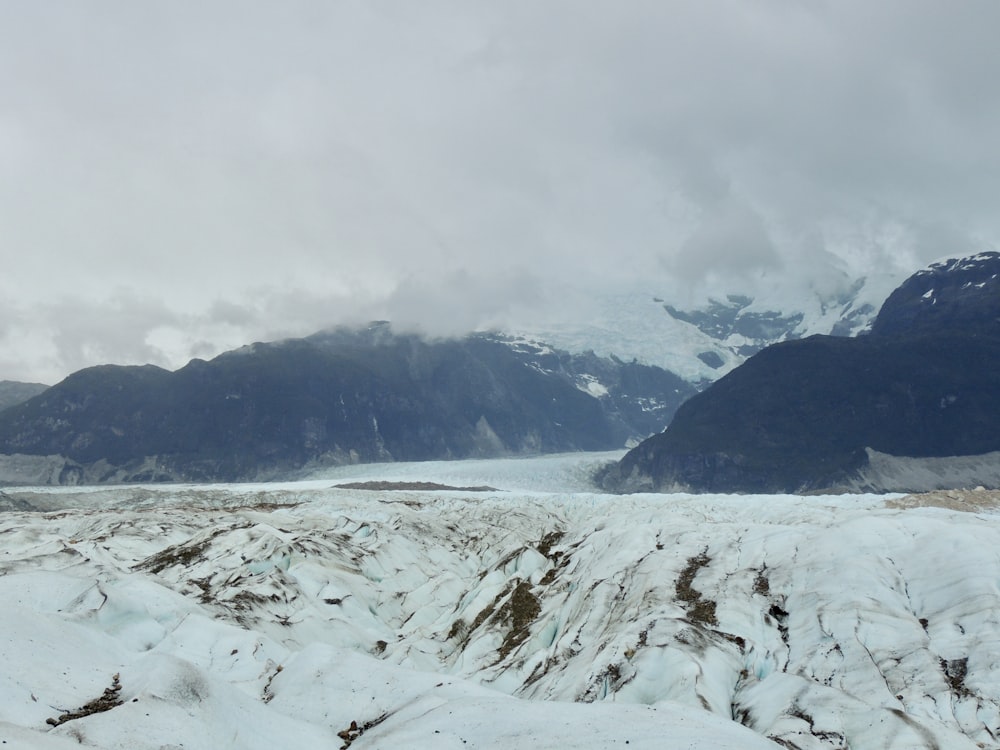 snow covered mountain under cloudy sky during daytime