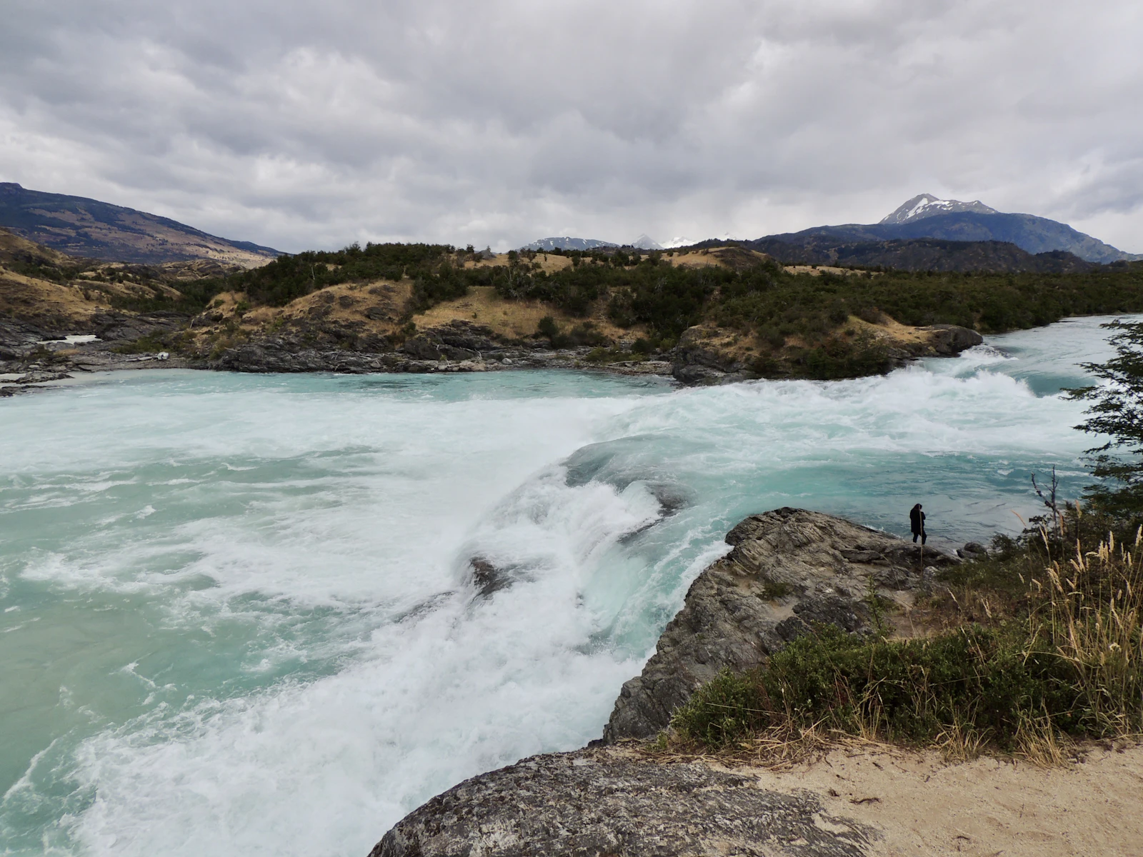 A traveler looking over a Patagonian lake far from services