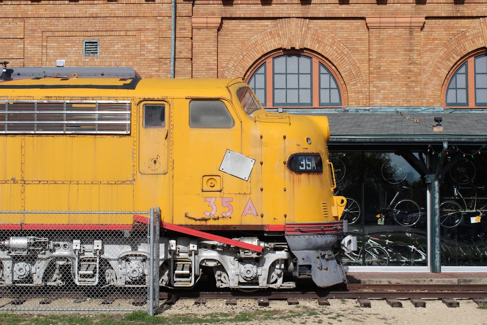 yellow train on rail tracks