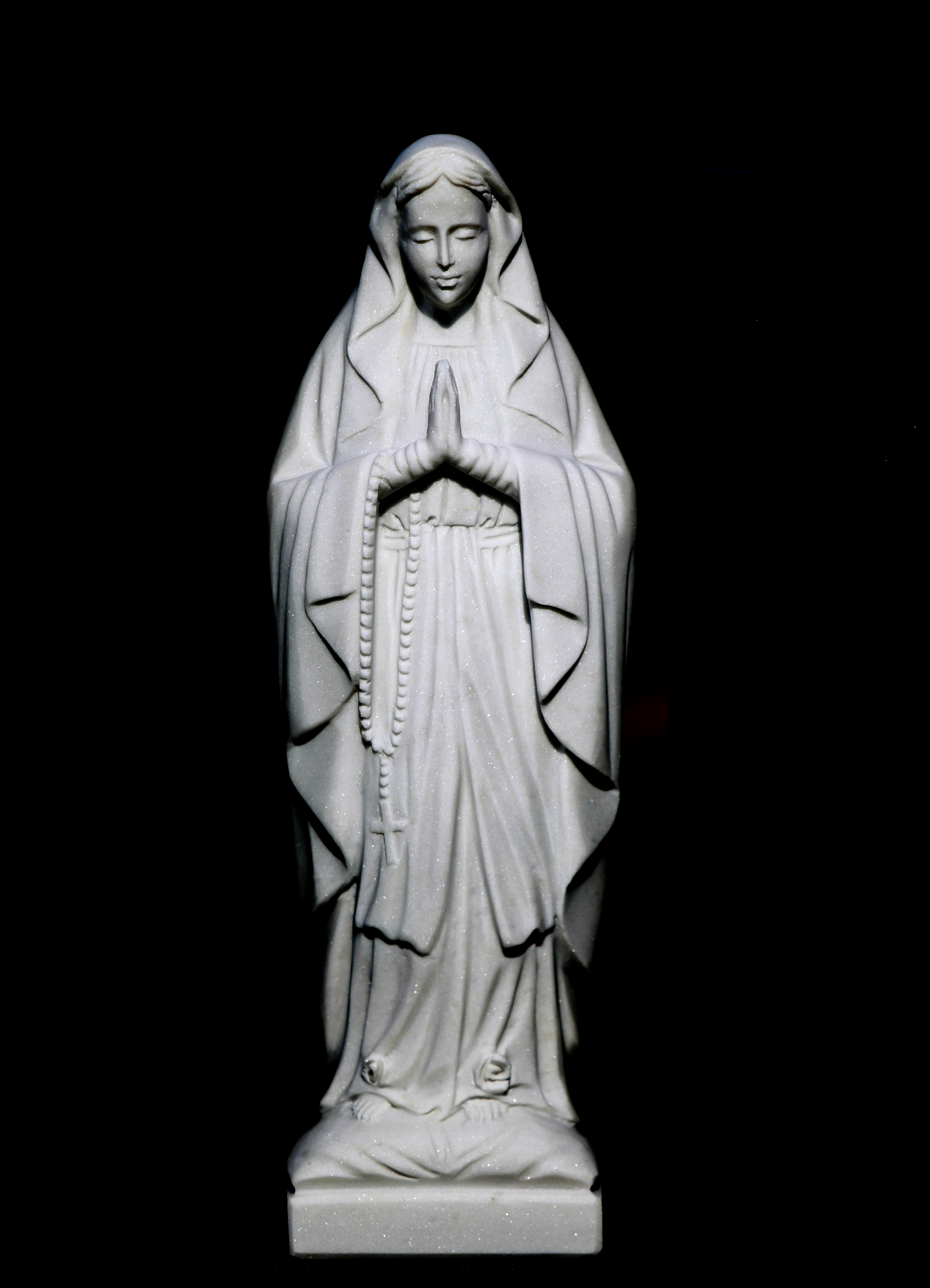 Statuette of woman praying on grave