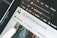 Close-up of a computer screen displaying an open web browser with multiple tabs, including a tab showing the Unsplash website. Other visible icons include web apps like Gmail, YouTube, and Maps. The search bar on the page invites users to look for free high-resolution photos.