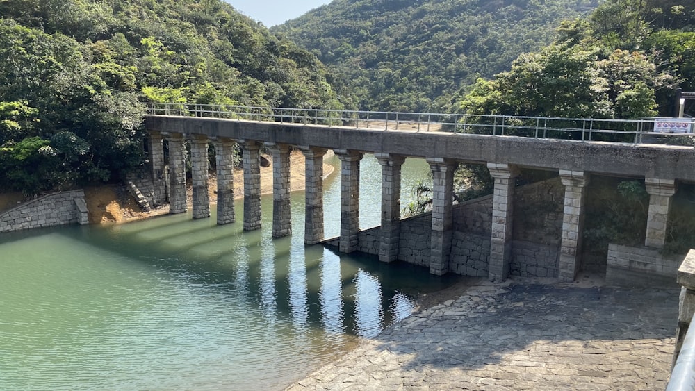 a bridge over a body of water surrounded by mountains