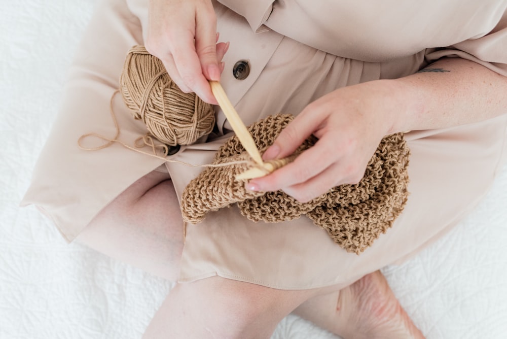 person holding white and brown stick