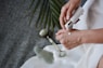 person holding white plastic bottle pouring white liquid on white ceramic mug