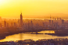 A tall city skyline shot during golden hour with warm hues.