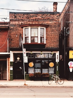 Charming brick storefront on a bustling street corner.
