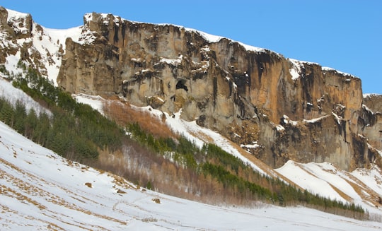 snow covered mountain under blue sky during daytime in Höfn Iceland