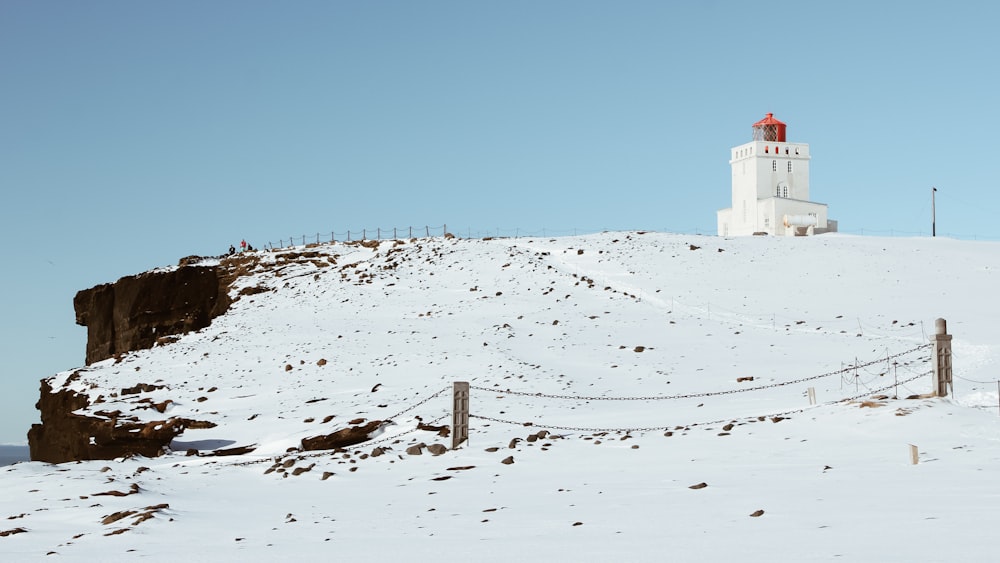 white and red concrete building on snow covered ground under blue sky during daytime