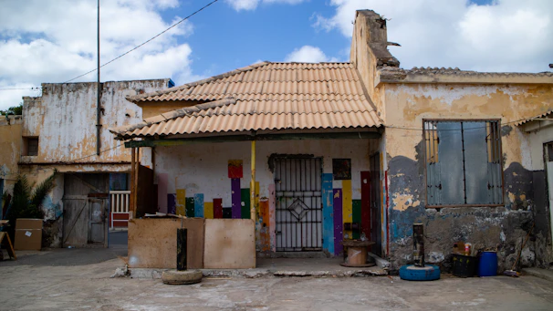 brown and white concrete house under blue sky during daytime