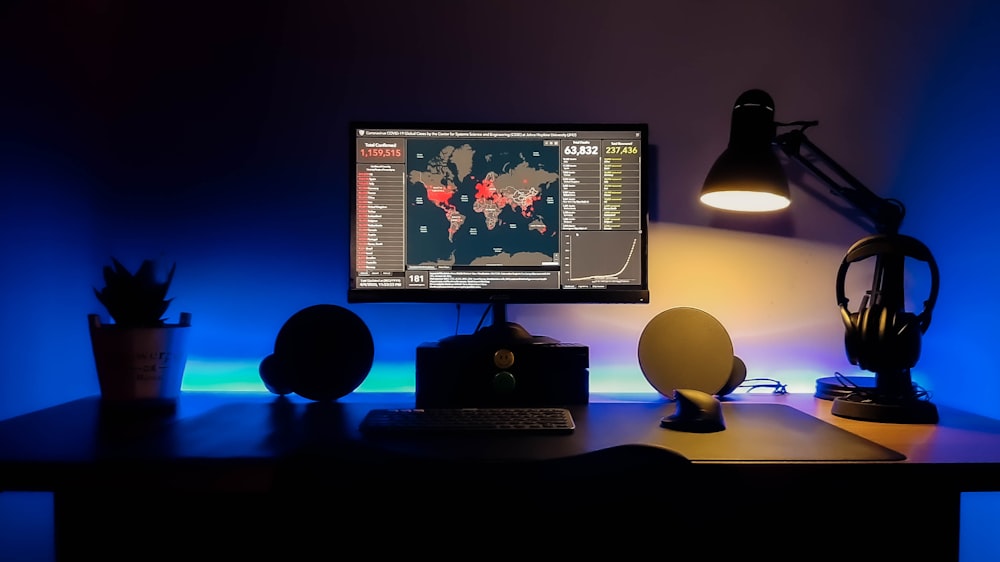 black flat screen computer monitor on brown wooden desk