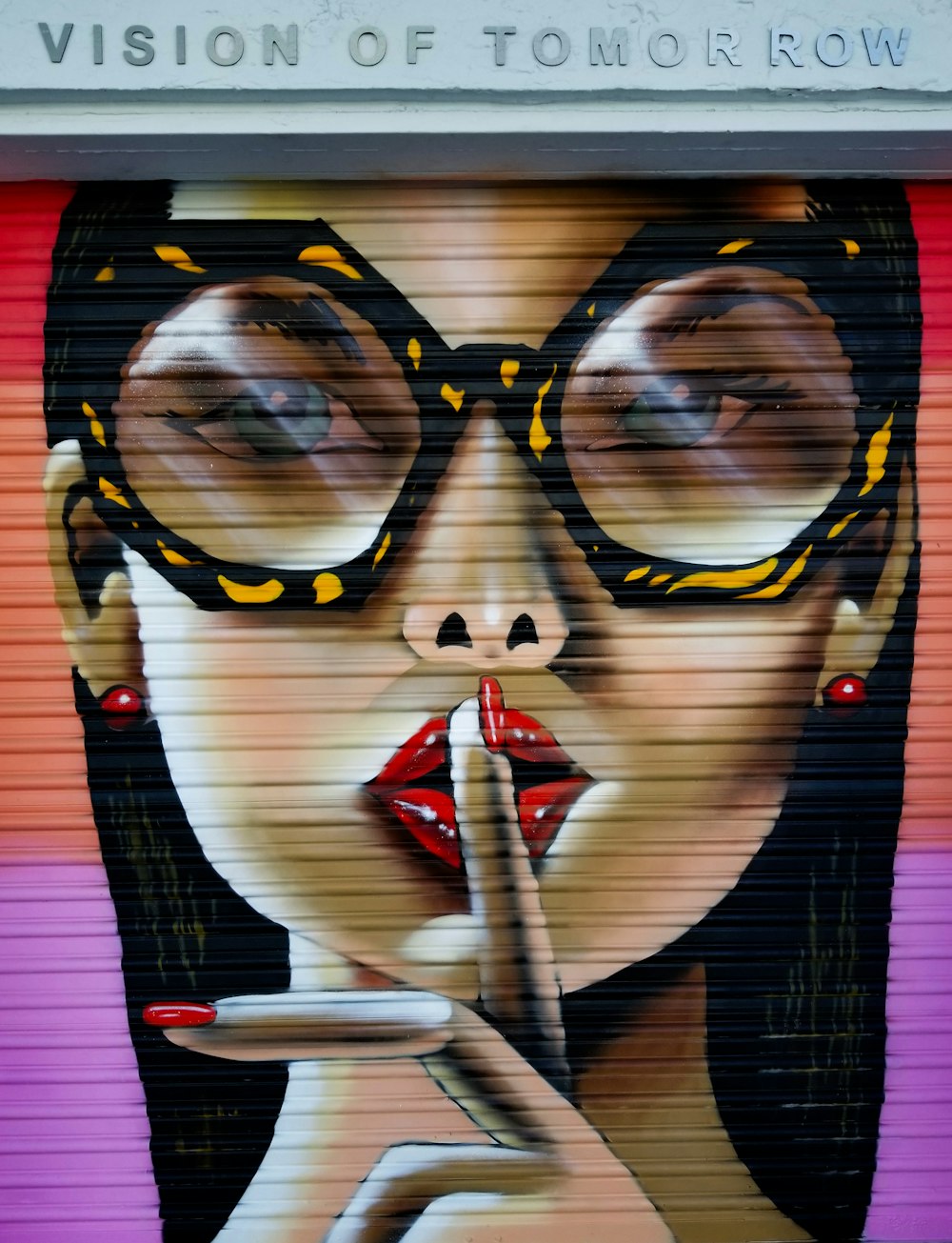 woman in black framed eyeglasses holding red and white tube