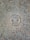 A metal survey marker is embedded in a textured concrete surface. The marker features a star in the center and has the words 'City of Austin Survey Marker' engraved on it. The concrete is speckled with various shades of gray, brown, and orange.