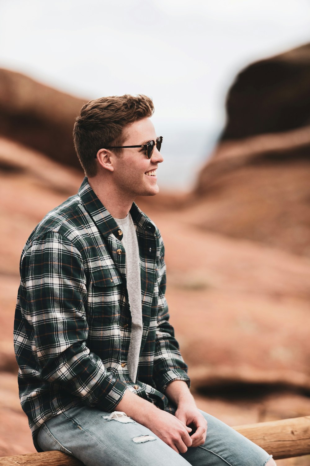 man in black and white plaid dress shirt wearing black sunglasses