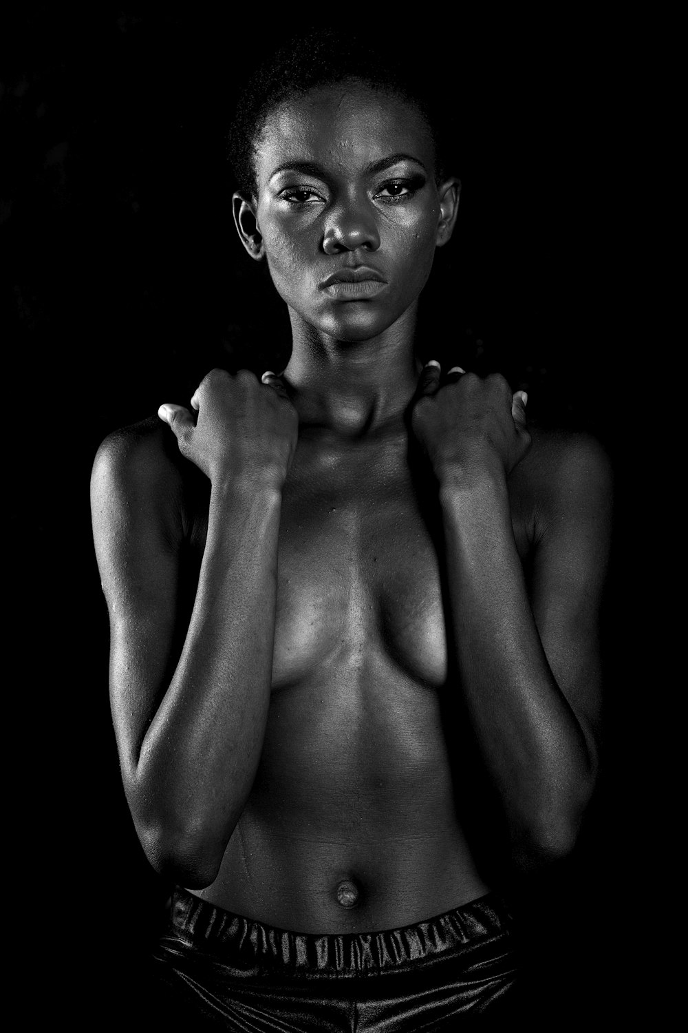 topless woman with black background