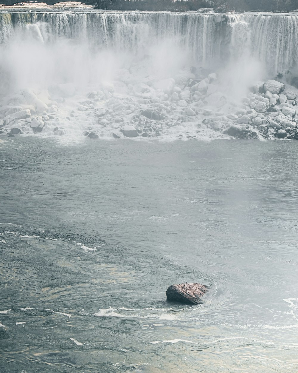 water waves hitting rocks during daytime