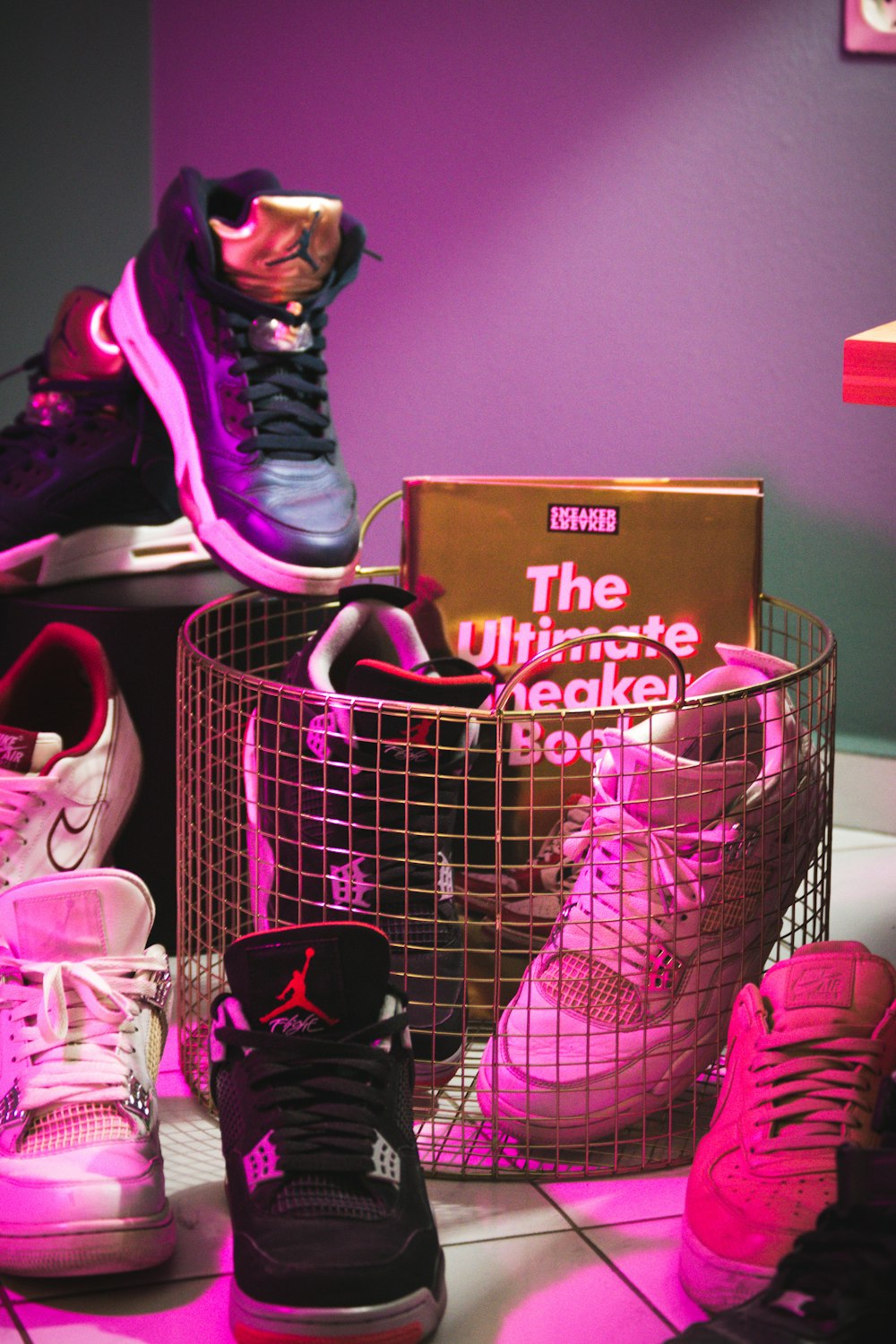 girl in pink and black jacket sitting on pink shopping cart