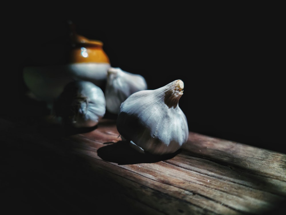 white garlic on brown wooden table