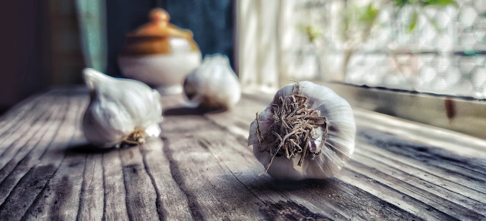 white garlic on brown wooden table