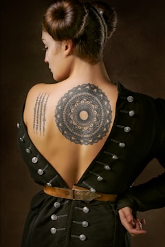 woman in black geometric tattoo on her back