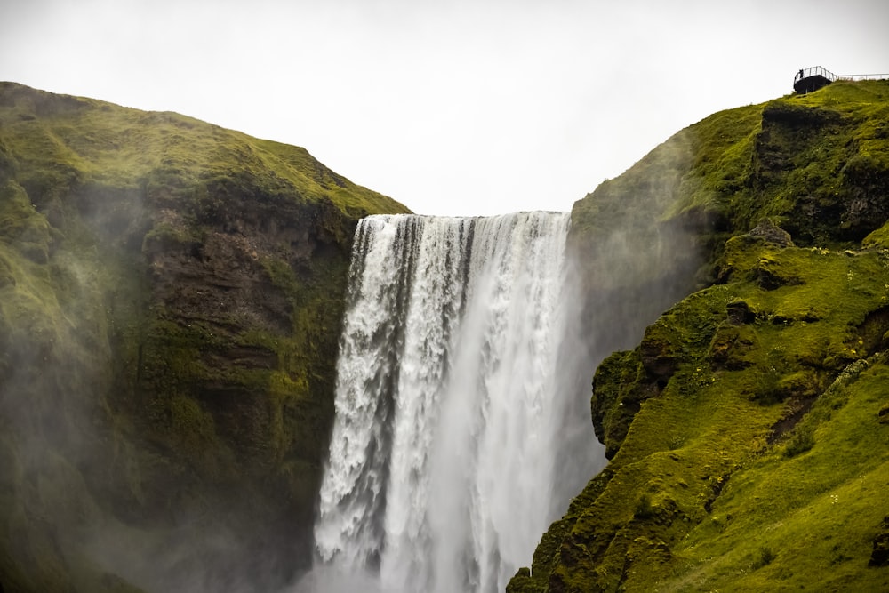 waterfalls on green and brown mountain during daytime