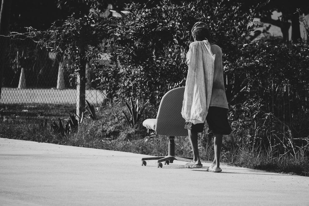 woman in white coat walking on road