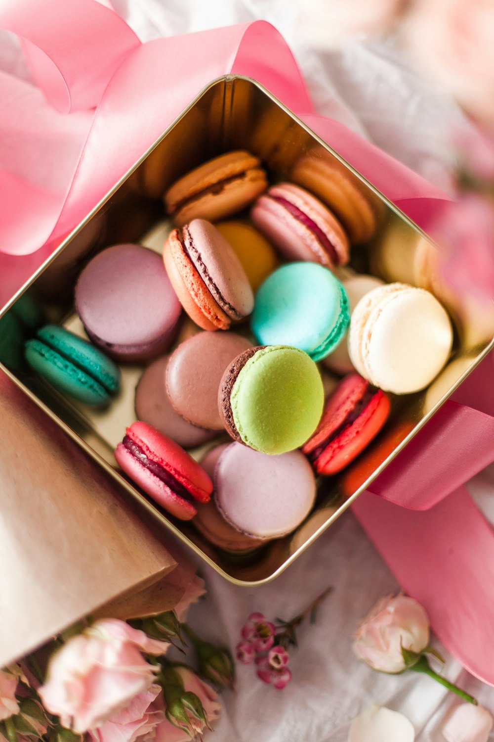 white green and pink round candies in box