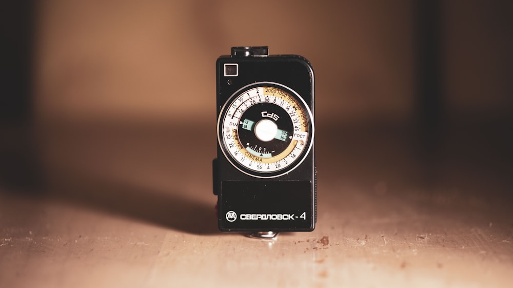 black and silver camera on brown wooden table