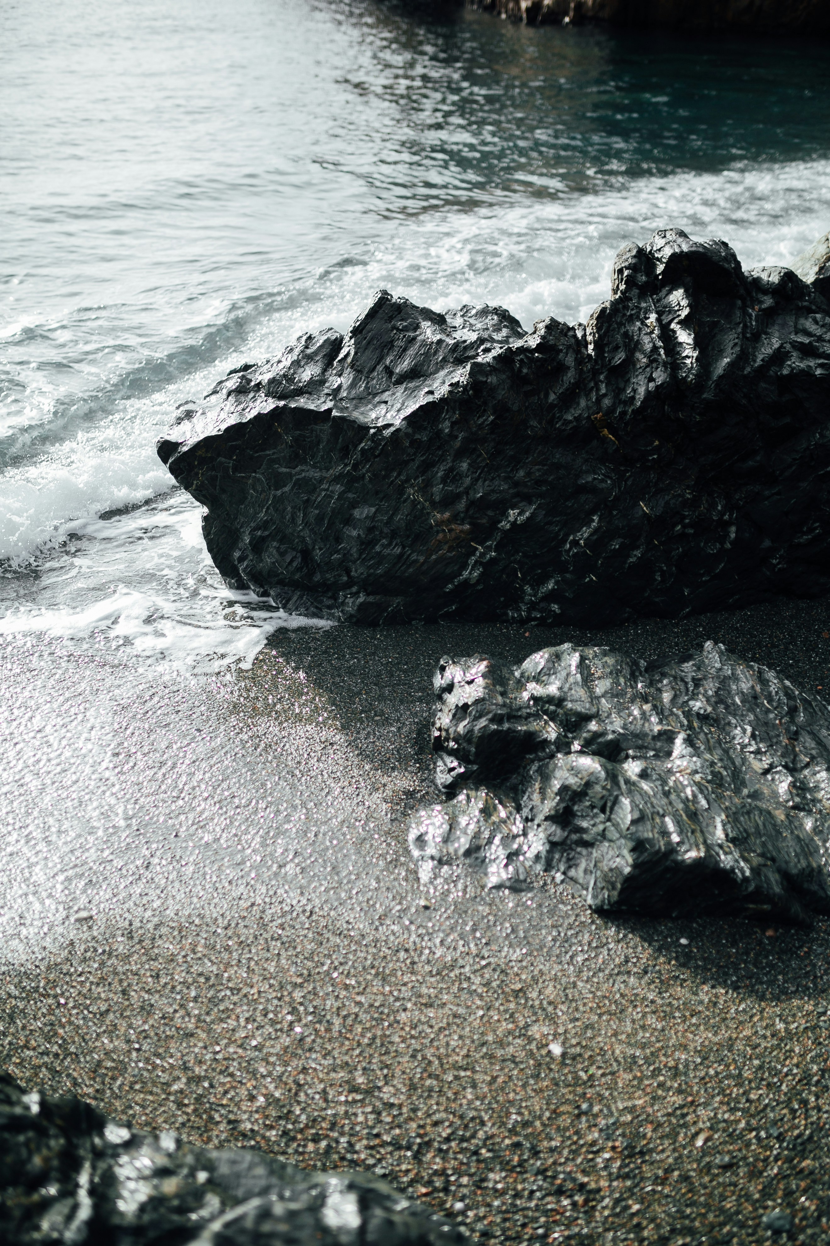 Black rock formation on sea shore during daytime photo – Free Black ...