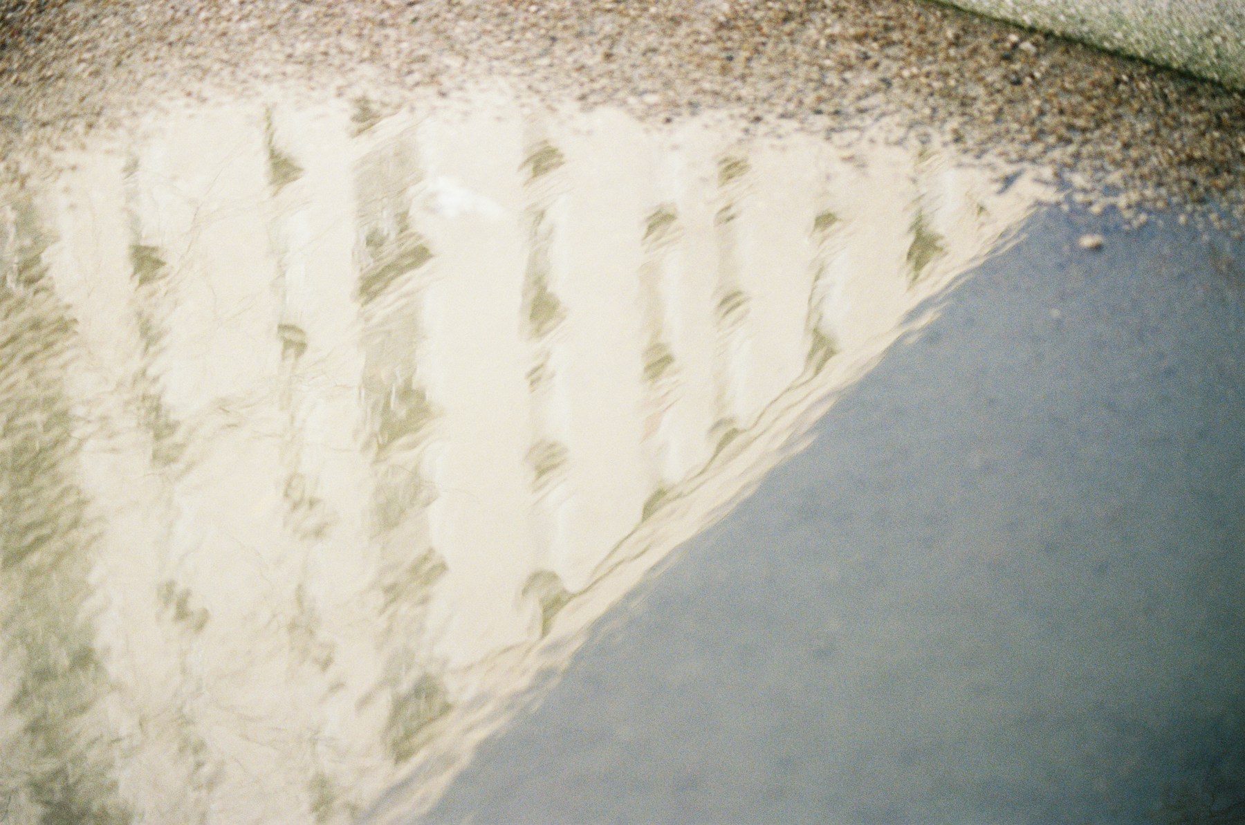 Notched adhesive combed across a prepared concrete slab