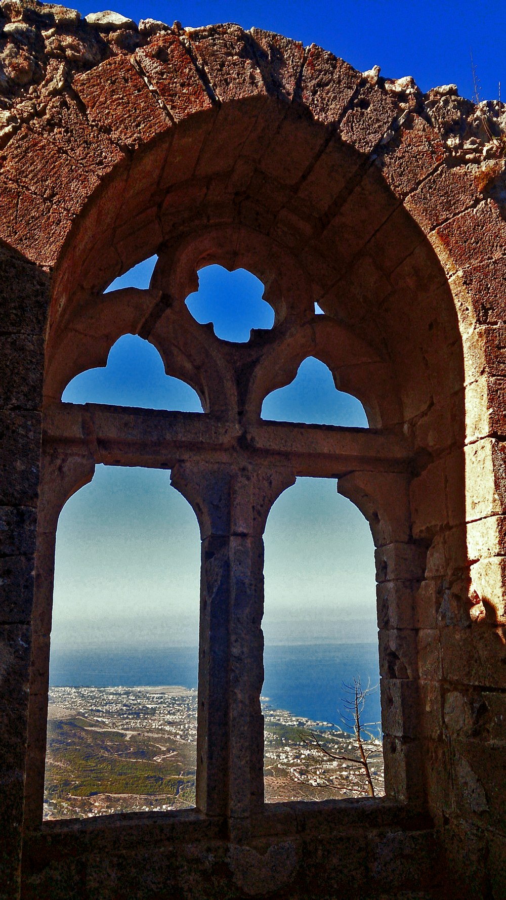 brown brick arch with blue sky in the distance